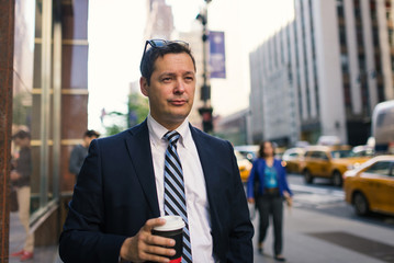 Businessman having a rest with a cup of coffee in Manhattan on t