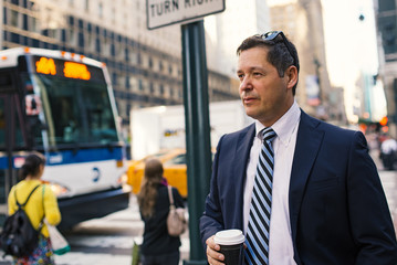 Businessman having a rest with a cup of coffee in Manhattan on t