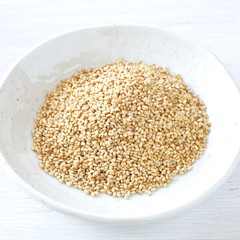 Organic natural sesame seeds on white wood table