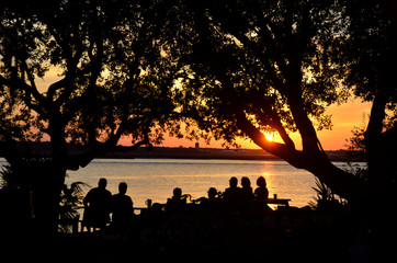 Silhouetted people looking at sunset Florida, USA