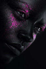 woman in black paint and neon pink powder