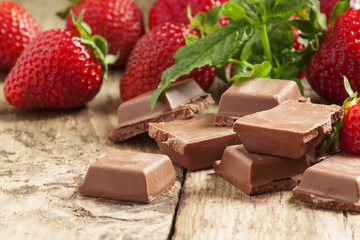 Milk chocolate and  strawberries, selective focus