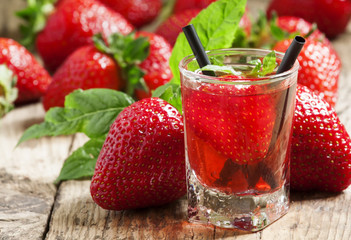 Fresh strawberry cocktail with berries and mint in a small glass, selective focus