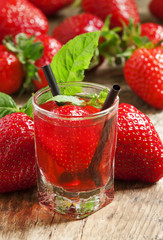 Fresh strawberry cocktail with berries and mint in a small glass, selective focus