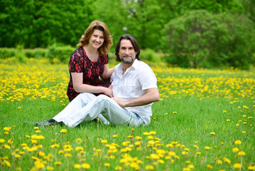 Fototapeta premium Adult male and female in park spring