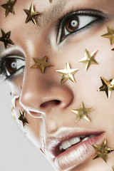 woman with gold stars on face