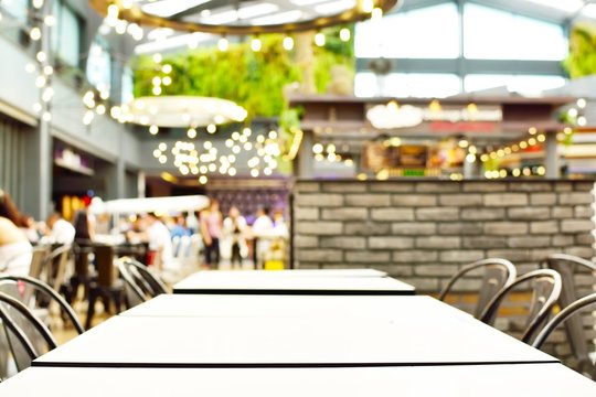  blur background with bokeh light of empty Table in coffee shop