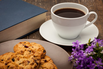 Cup of coffee and biscuits over wooden table