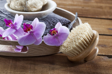 beauty ritual for spa treatment with natural sponge, towel, brush, loofah, flowers and massage accessory
