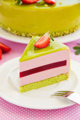 Delicious strawberry-pistachio mousse cake with a smooth glaze.