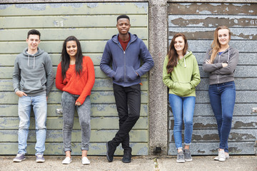 Gang Of Teenagers Hanging Out In Urban Environment