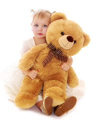 Caucasian little girl hugging a big Teddy bear