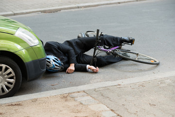 Male Cyclist After Car Accident On Road
