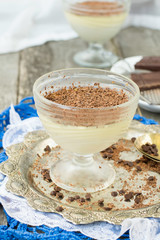Vanilla panna cotta with chocolate on a wooden background. selec