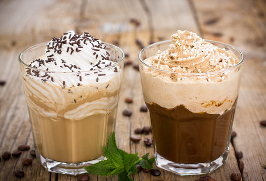 Two glasses of ice coffee with milk and whipped cream