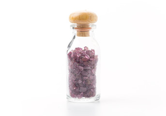 rhodolite in glass bottle isolated on white background