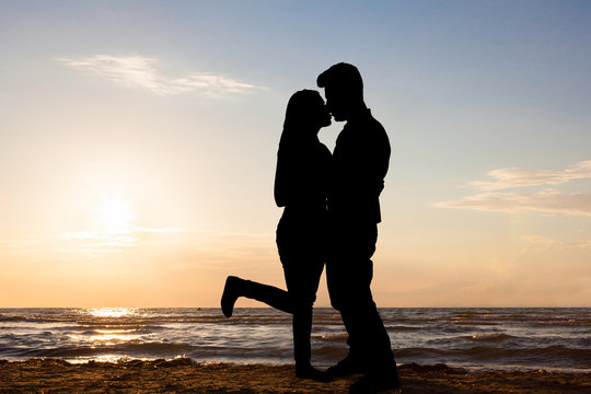 Silhouette Of Loving Couple At Beach