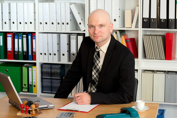 young businessman is looking friendly in to the camera