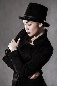 Beautiful young woman in a black hat