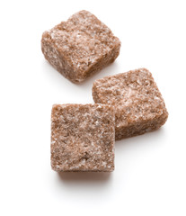 Brown lump cane sugar cube isolated on white background cutout