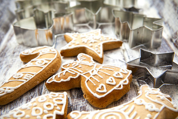 Christmas gingerbread cookies and metal cookie cutters on white