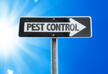 Pest Control direction sign with a beautiful day