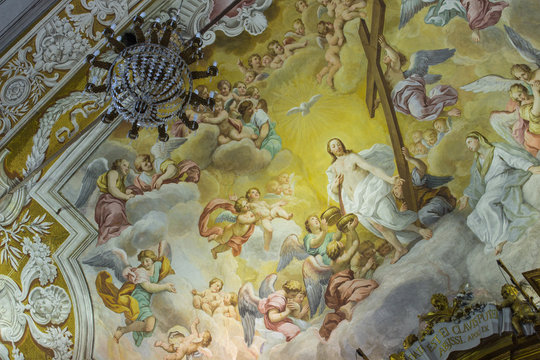 A colorful Italian Renaissance fresco on the arched ceiling of an ancient church.