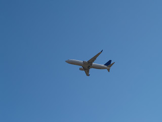 Fototapeta na wymiar Commercial Jet Liner Climbing Into Blue Sky