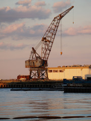 Fototapeta premium Rusted Grey Crane Harbor Against Cloudy Sky
