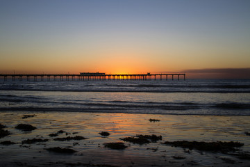 Fototapeta na wymiar Sunset behind Ocean Beach Pier, San Diego, California