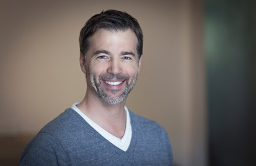 Close-up of a mature man smiling at home