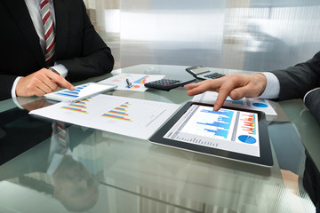 Two Businessman Working On Digital Tablet