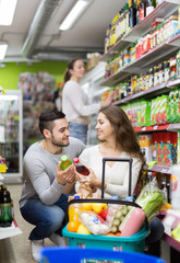 Naklejka premium Customers at beverages section of supermarket