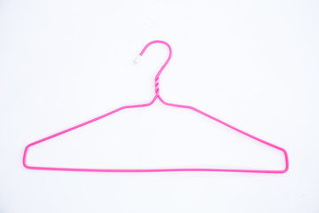 Pink wire hangers on white background