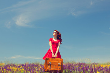 girl in red dress with suitcase