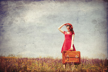 girl in red dress with suitcase