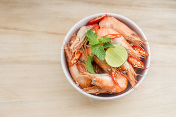 Shrimps and lemon in white bowl