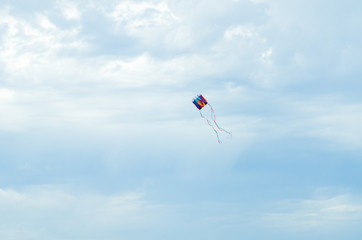 Colorful kite lonely filying in the blue sky