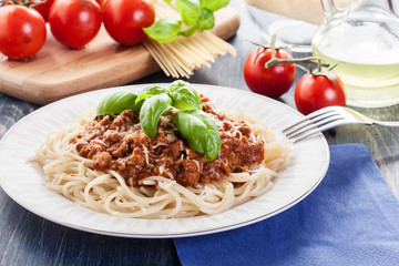 Spaghetti bolognese with cheese and basil