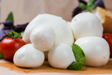 balls mozzarella different size with tomatoes cherry, bread and