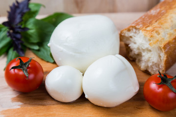 balls mozzarella different size with tomatoes cherry, bread and