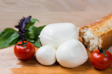 balls mozzarella different size with tomatoes cherry, bread and