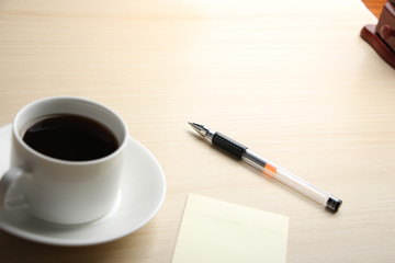 Blank note with ball pen and coffee