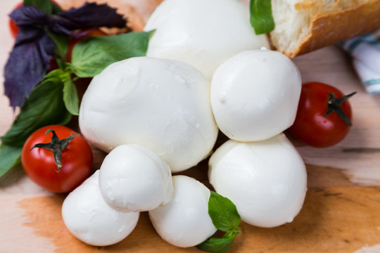 balls mozzarella different size with tomatoes cherry, bread and