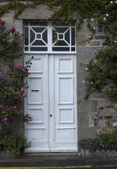 A door framed by roses