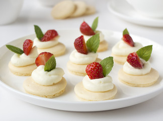 Cakes with strawberry, whipped cream, jelly and mint