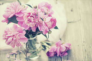 Pink peonies on wooden background - vintage photo
