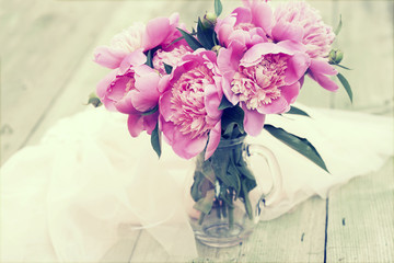 Pink peonies on wooden background - vintage photo