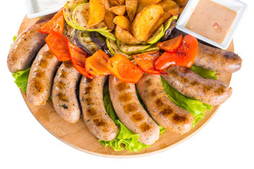 Grilled sausages with vegetables and sauce