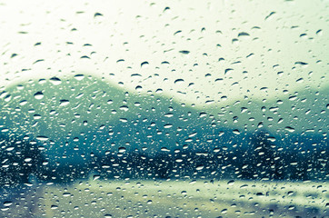 raindrops on auto glass with mountain view in vintage style